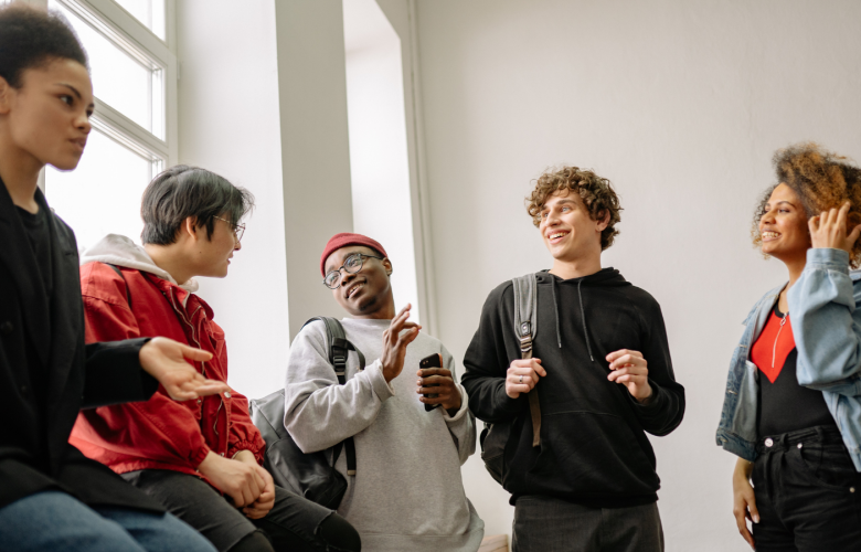 Young people talking in a corridor 