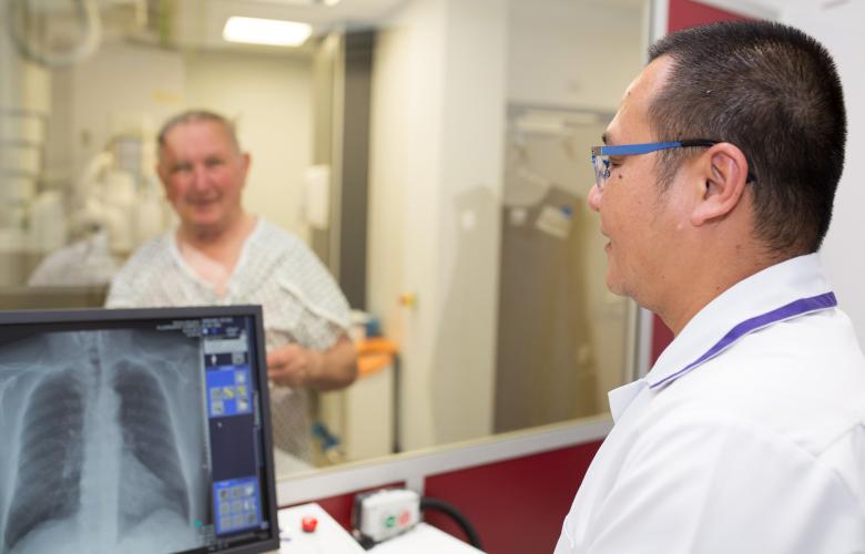 A radiographer working with a patient. 