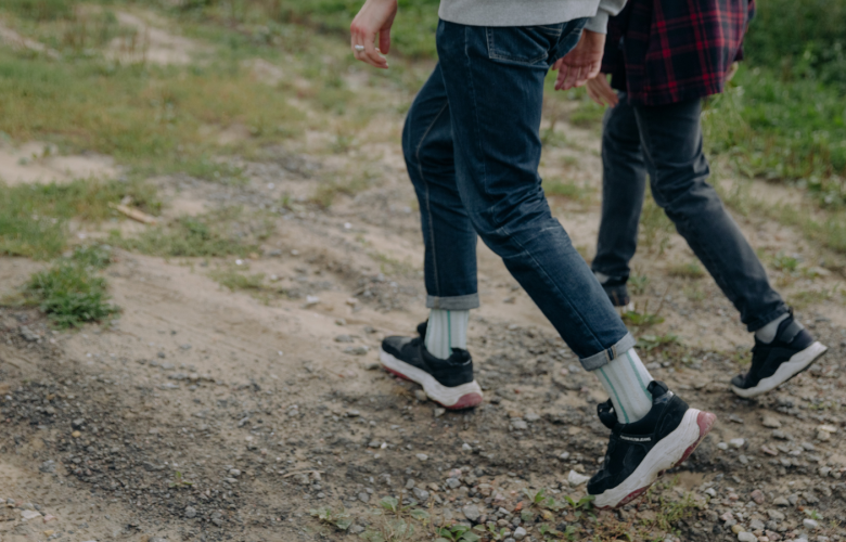 Two people walking outside, with a close-up shot of their legs walking in sync.