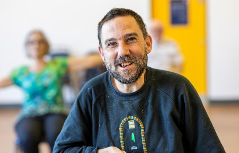 A man smiling indoors. 