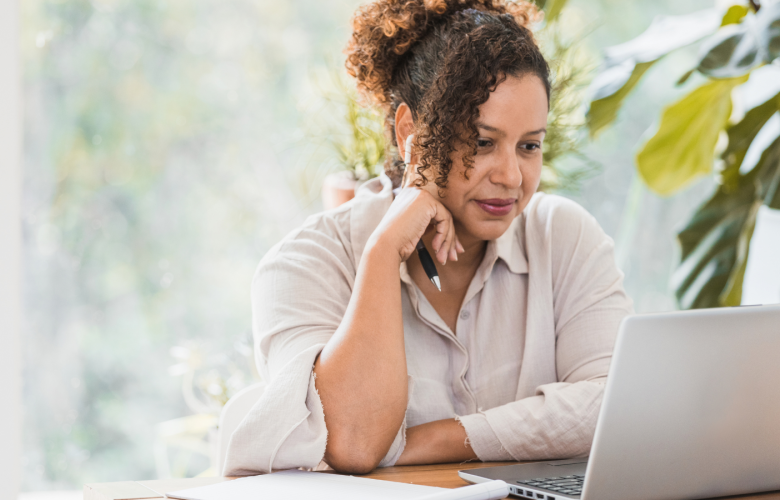 Woman reading a laptop screen indoors