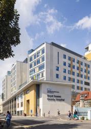 Royal Sussex County Hospital Louisa Martindale building next to tree and terraced housing.