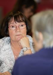 Two older adults talking.