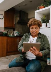 Woman looking at iPad indoors.