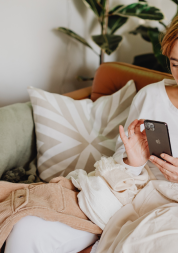 Woman using phone on sofa