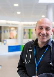 A doctor smiling in a hospital