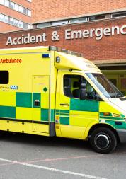 yellow and green ambulance outside a hospital