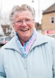 Elderly woman smiling face on to the camera