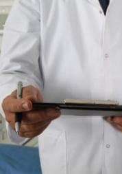Photograph, Man in white coat holding clipboard, Front view, Shoulders and Below