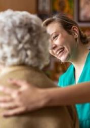 Social care worker helping woman.